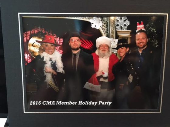 Celebrating the holidays with co-writer Adam Searan, Santa Claus, and new acquaintances at the CMA Christmas party in Nashville.